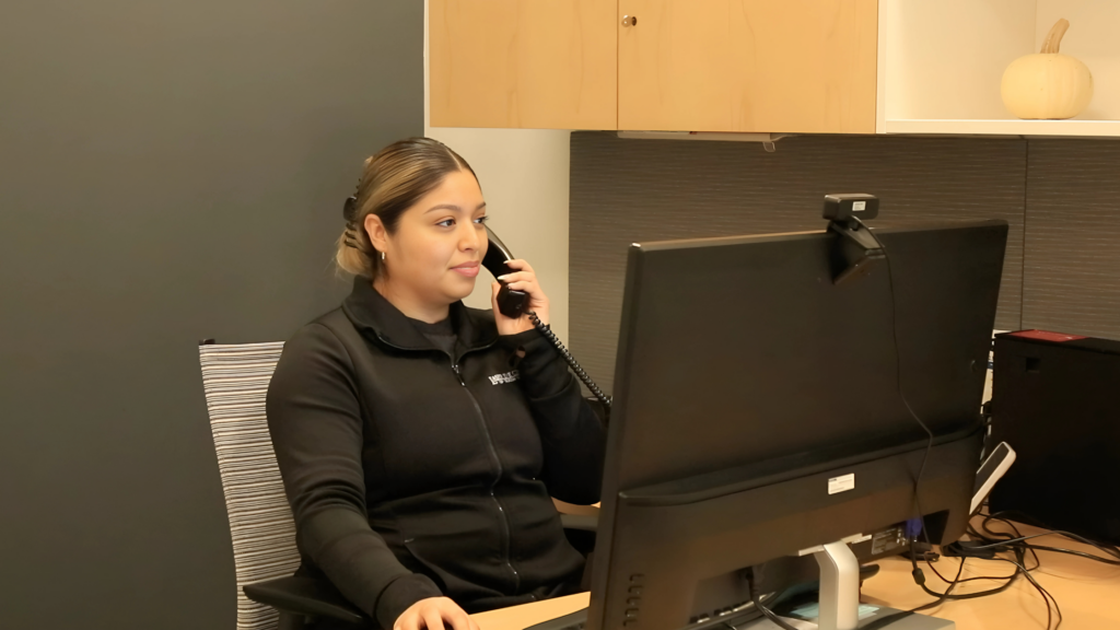 A friendly LEC team member answering a patient call in the evening, emphasizing 24:7 accessibility